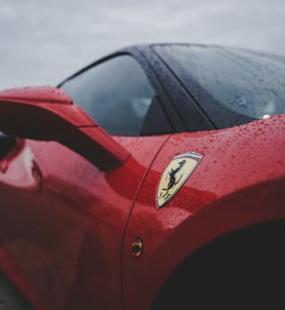 A red Ferrari in the rain